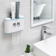Laden Sie das Bild in den Galerie-Viewer, Ecoco wall-mounted toothbrush holder with automatic toothpaste dispensers, perfect for organizing toothbrushes and toothpaste in a modern, space-saving design; sleek white finish with subtle blue accents to blend seamlessly with contemporary bathroom decor, featuring convenient, hygienic storage for easy access to daily essentials.