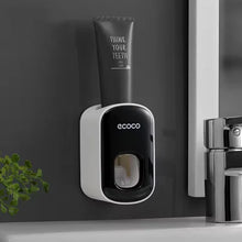 Laden Sie das Bild in den Galerie-Viewer, Black toothpaste dispenser on a bathroom wall