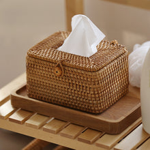 Laden Sie das Bild in den Galerie-Viewer, Natural woven rattan tissue box cover placed on a sleek wooden tray, enhancing a minimalist shelf arrangement. Perfect for adding an earthy and functional touch to bathrooms, living rooms, or office spaces