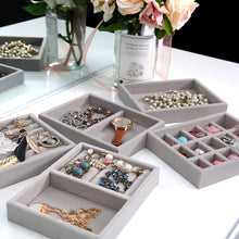 Load image into Gallery viewer, "Multiple gray velvet jewelry trays displayed on a sleek white vanity, each meticulously organized with elegant accessories such as pearl necklaces, statement earrings, delicate bracelets, and a classic wristwatch. A bouquet of pastel flowers in a glass vase adds a charming aesthetic, highlighting the perfect combination of style and functionality for keeping precious jewelry neatly stored and easily accessible.