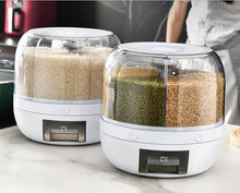 Laden Sie das Bild in den Galerie-Viewer, Two MessFree® rotating grain dispensers on a kitchen counter, each filled with different grains including rice, green beans, and chickpeas. The dispensers feature a transparent, compartmentalized design with an easy-access pull-out tray for convenient dispensing.