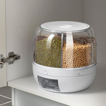 Laden Sie das Bild in den Galerie-Viewer, Rotating grain dispenser with transparent compartments, neatly holding various dry goods like lentils, beans, and grains. The compact, white container has a clear, rotating lid for easy access to each compartment, ideal for organizing pantry staples.