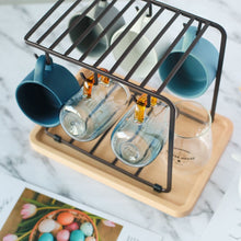 Load image into Gallery viewer, MessFree® cup rack in black, displaying an assortment of mugs and glasses. The rack is designed with multiple hooks and a sturdy top frame for efficient storage, placed on a light wooden tray, ideal for organizing cups and glasses in a compact space.