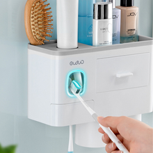 Laden Sie das Bild in den Galerie-Viewer, Wall-mounted bathroom organizer with a built-in toothpaste dispenser and LED toothbrush sterilizer, ensuring hygiene and convenience in one compact design. This multipurpose storage solution offers space for toiletries, brushes, and cosmetics, keeping your sink area organized and clutter-free.