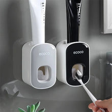 Laden Sie das Bild in den Galerie-Viewer, Grey and black toothpaste dispensers above a sink
