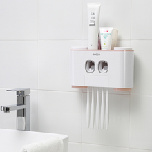 Load image into Gallery viewer, &quot;Wall-mounted toothbrush holder with dual automatic toothpaste dispensers by Ecoco, featuring storage for multiple toothbrushes and toothpaste tubes, perfect for organizing bathroom essentials in a compact and hygienic way, minimalist white and pink design on tiled bathroom wall, ideal for family use and space-saving bathroom storage.
