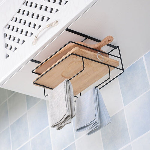 Under-cabinet storage rack holding a wooden cutting board with two neatly folded cloths hanging below. The sleek black metal frame adds an elegant touch, maximizing space while keeping kitchen essentials within easy reach.