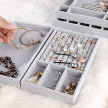 Load image into Gallery viewer, Close-up of premium gray velvet jewelry trays featuring meticulously organized compartments filled with elegant accessories. Displayed items include gold bracelets, pearl earrings, sparkling studs, intricate necklaces, and dainty charms. A luxurious and practical solution for keeping your jewelry collection sorted and easily accessible, perfect for enhancing a sophisticated dressing space.
