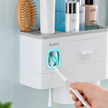 Laden Sie das Bild in den Galerie-Viewer, Wall-mounted bathroom organizer with a built-in toothpaste dispenser and LED toothbrush sterilizer, ensuring hygiene and convenience in one compact design. This multipurpose storage solution offers space for toiletries, brushes, and cosmetics, keeping your sink area organized and clutter-free.
