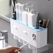 Laden Sie das Bild in den Galerie-Viewer, &quot;Multifunctional wall-mounted bathroom organizer featuring an automatic toothpaste dispenser, spacious compartments for toiletries, and a sleek storage shelf for added convenience. This compact unit keeps your daily essentials organized and within easy reach, making it ideal for maximizing space and maintaining a clutter-free sink area
