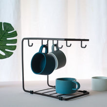 Load image into Gallery viewer, MessFree® cup rack featuring a minimalist black metal design, holding two mugs on top hooks and additional space for mugs on the bottom rack, ideal for organizing cups in a modern kitchen.
