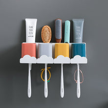 Laden Sie das Bild in den Galerie-Viewer, Four cup cloud toothbrush holder on a grey wall
