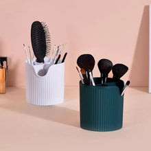 Load image into Gallery viewer, White and green brush holders on a pink shelf
