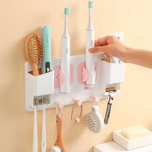 Laden Sie das Bild in den Galerie-Viewer, Taking a toothbrush from a wall rack
