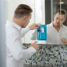 Load image into Gallery viewer, Man using a silicone toothbrush holder on a mirror
