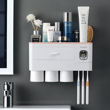 Laden Sie das Bild in den Galerie-Viewer, Pink wall-mounted toothbrush holder with 3 cups and toothpaste dispenser
